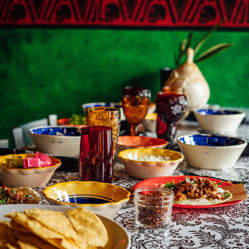 Table with tacos and pozole.